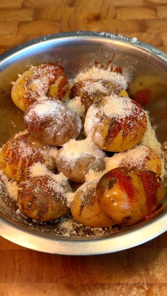 
 Season before boiling: Toss the whole potatoes with spices and parmesan to lock in flavor from the start.