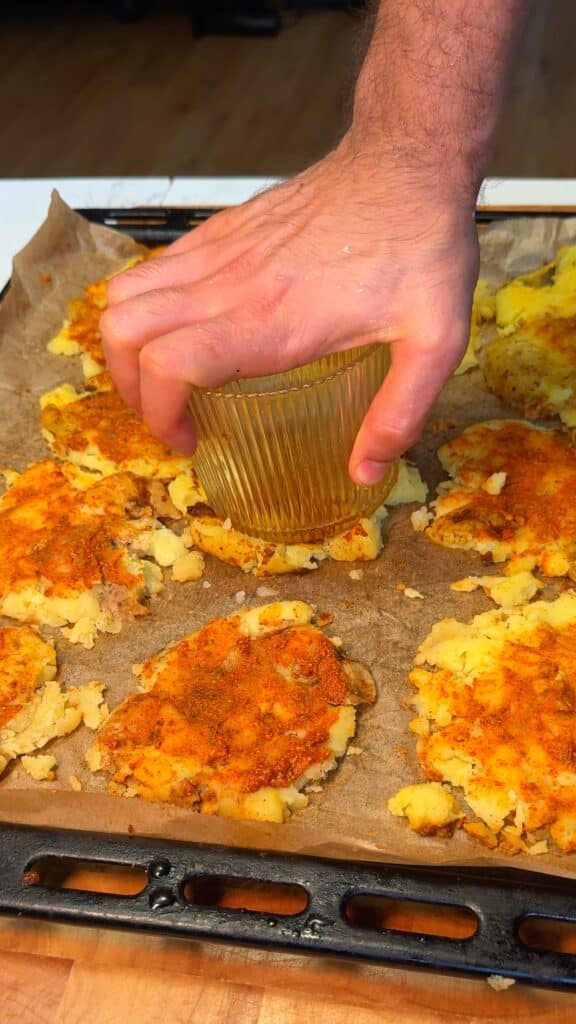 
 Smash the potatoes evenly: Use a glass or potato masher to press each one down to about ½ inch thick.