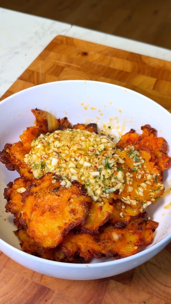 Top the smashed potatoes generously: Pour the hot garlic-chili butter over the potatoes right out of the oven so they soak up all the flavor.