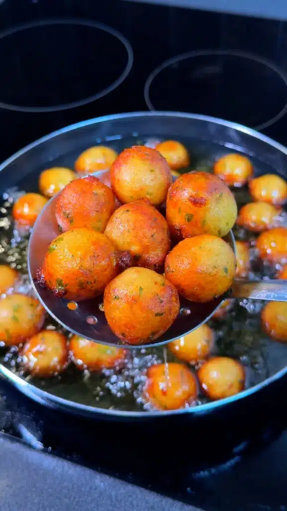 Potato balls frying in hot oil