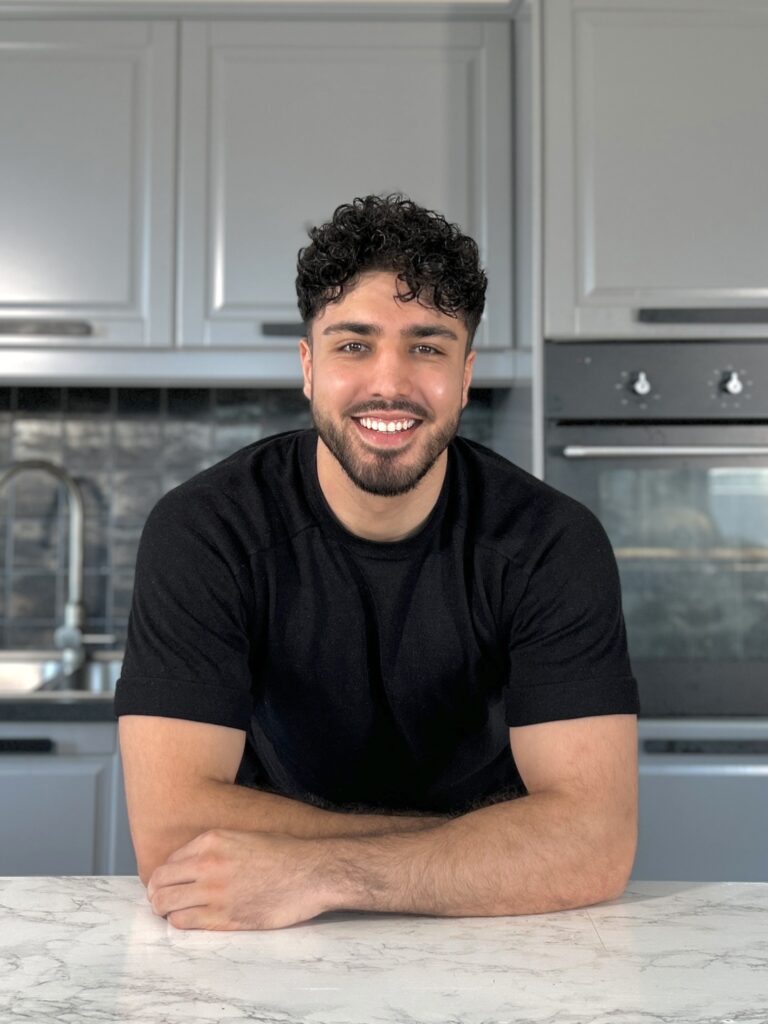 Profile Picture of Ahmad Noori (Dr. Vegan) in front of his kitchen