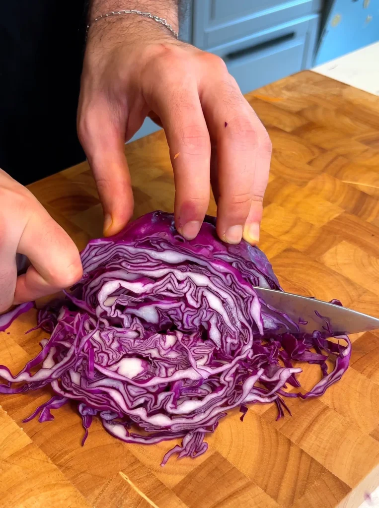 Thai Peanut Noodle Salad meal prep cutting red cabbage