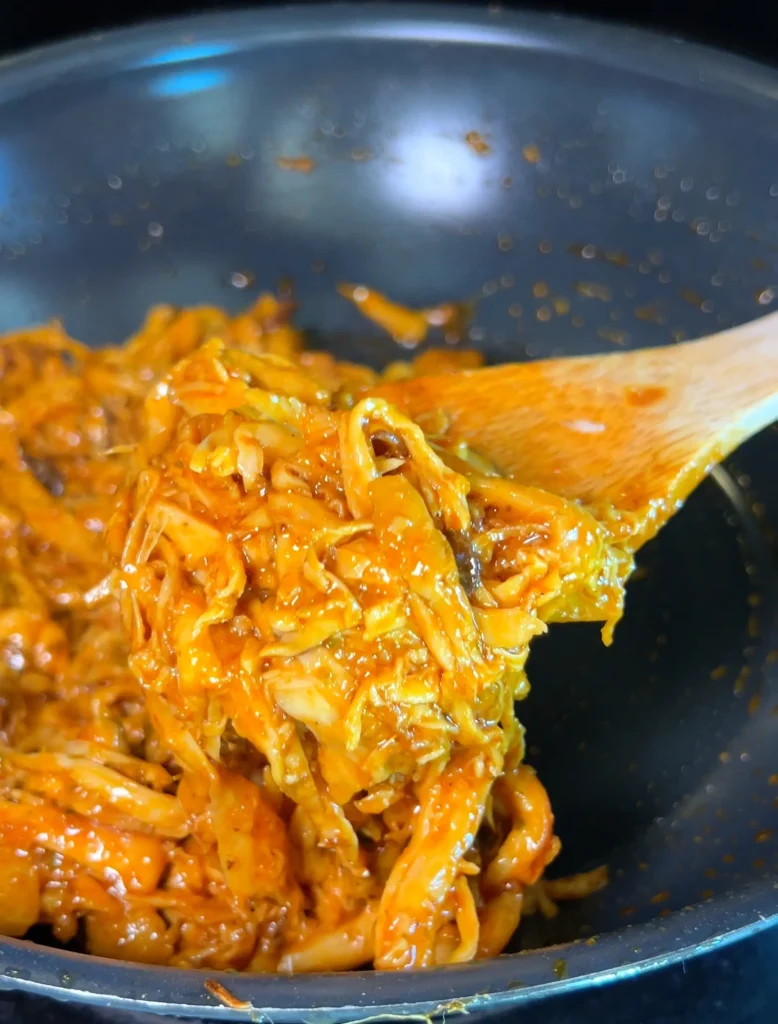 Simmering seasoned mushrooms in a pan