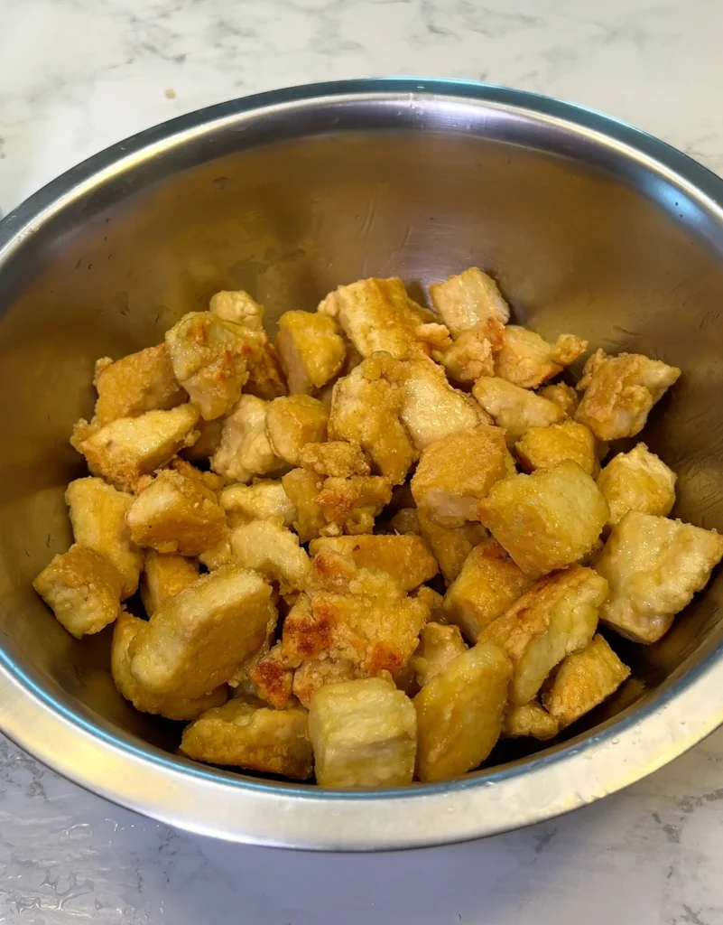 Crispy cooked tofu chunks in a bowl.