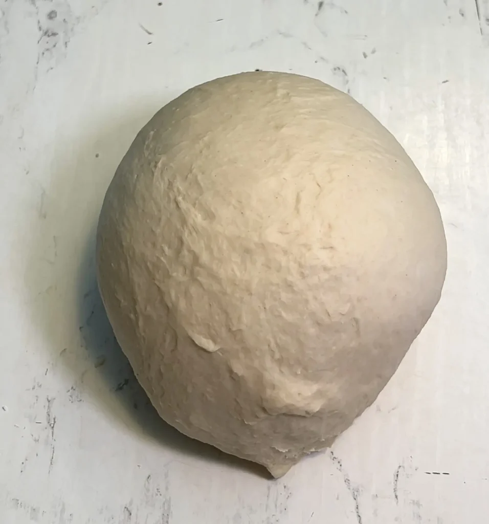 Smooth ball of freshly kneaded empanada dough