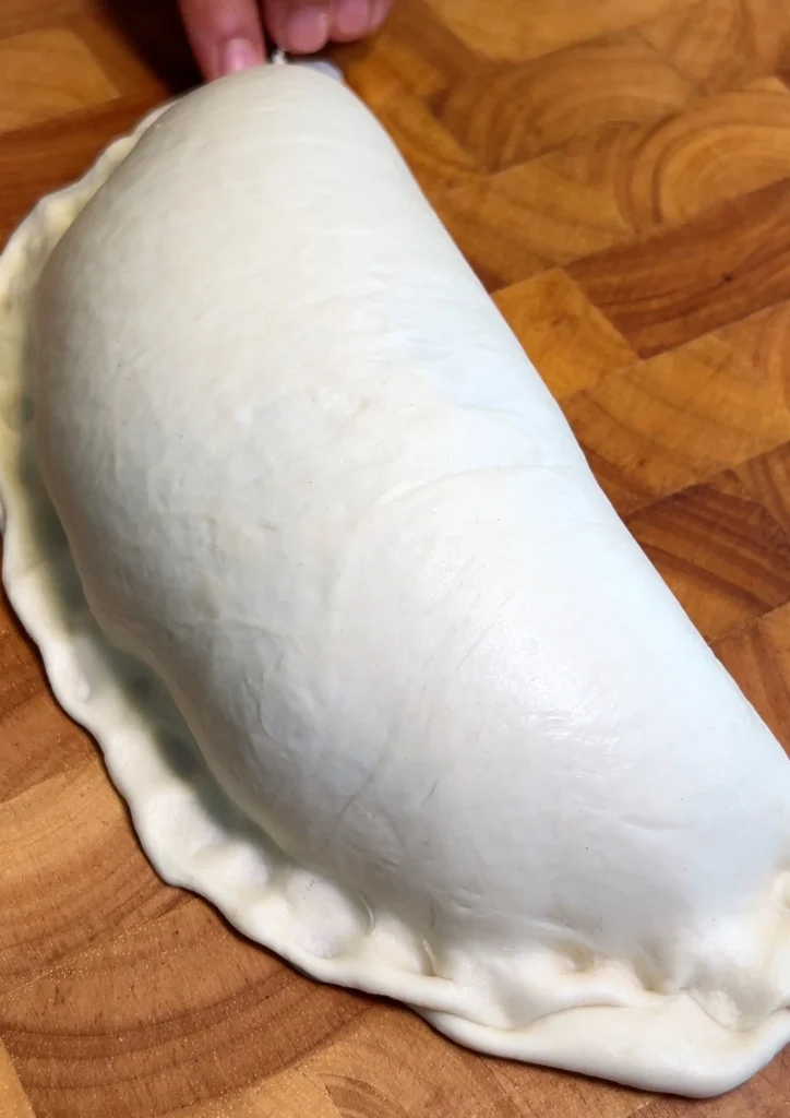 Folded and sealed empanada dough before frying