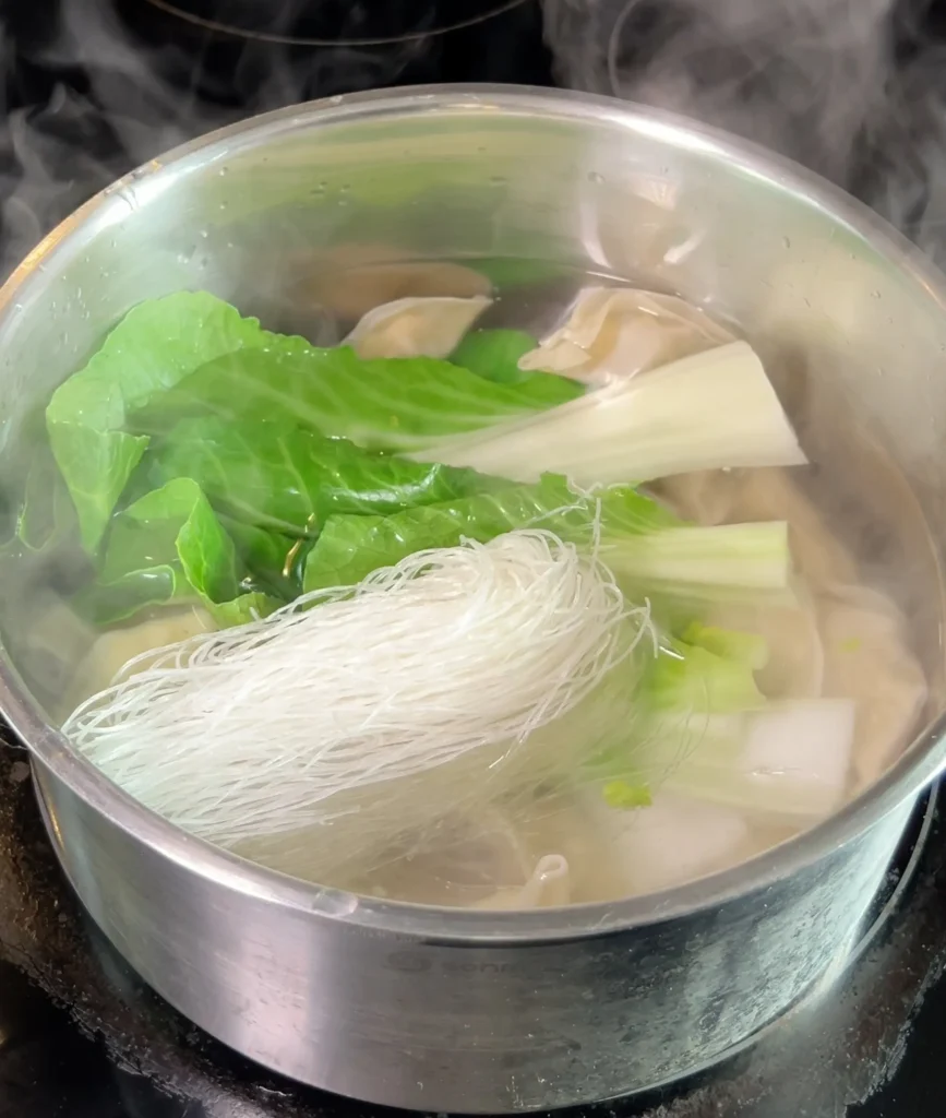 Dumpling soup cooking noodles