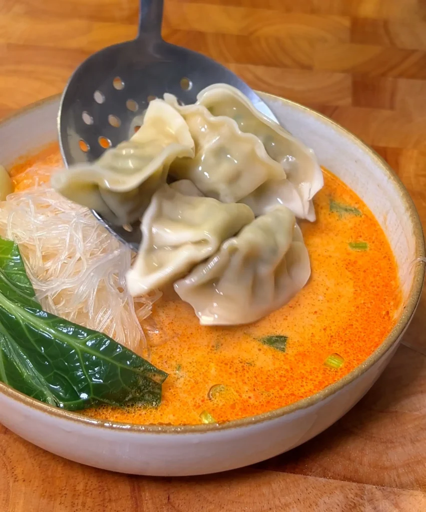 Dumpling soup cooking adding noodles