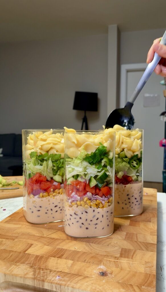 layering the taco pasta salad in a jar