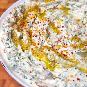 creamy roasted garlic dip in a white plate