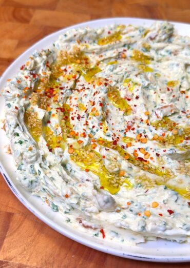 creamy roasted garlic dip in a white plate