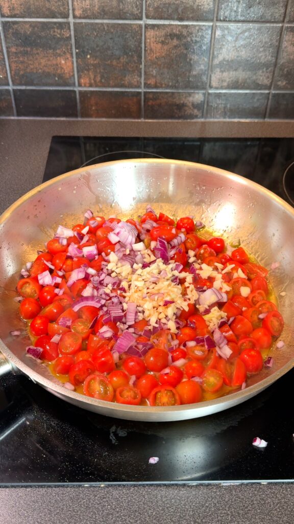 Cooking tomatoes, garlic, and onion until soft.