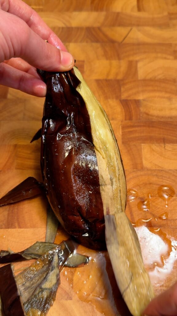 roasted eggplant being peeled