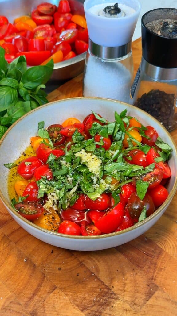 Mix your topping: Toss cherry tomatoes, basil, garlic, olive oil, salt, and pepper in a bowl. Let the flavors marinate.