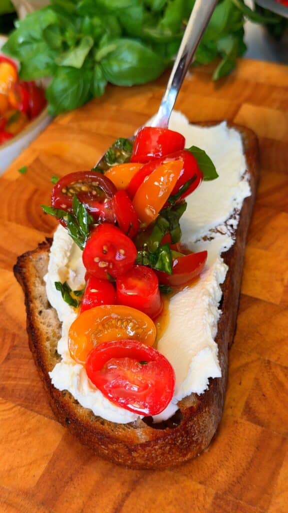 Spread & top: Add vegan cream cheese to each slice, then pile on the tomato mixture.