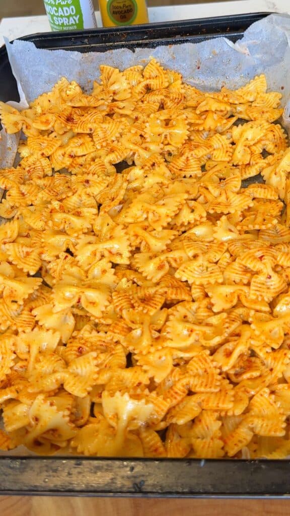 Cook pasta, drain, pat dry, then toss with oil and seasonings. Roast until crispy, flipping halfway.