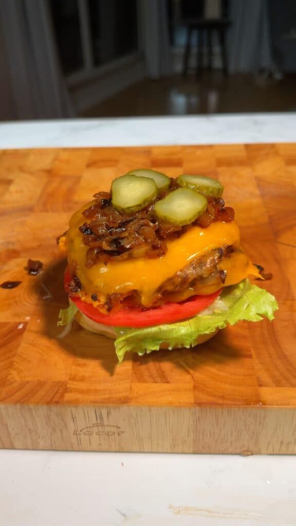 Assemble – Toast buns, spread sauce, and layer with lettuce, tomato, patty, onions, and pickles.