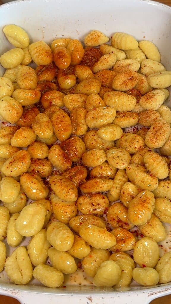 Toss gnocchi with oil and seasonings (no need to thaw if frozen), then cook in the air fryer or oven until golden and crispy, shaking or stirring halfway.
