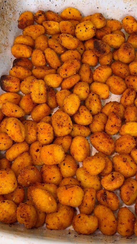 Toss hot gnocchi with vegan parmesan.