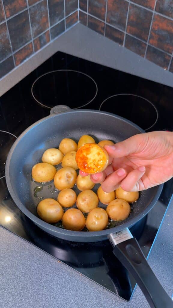 Sear halved potatoes cut-side-down in a pan with a pinch of salt until golden