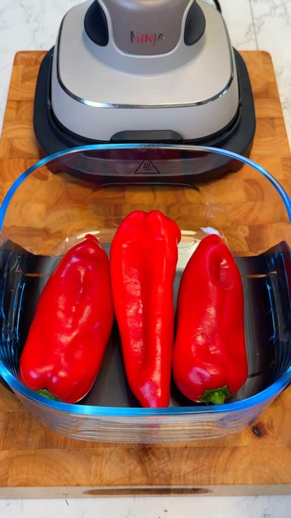 Cook the cauliflower and peppers: Roast or air-fry the cauliflower steaks and whole red peppers until golden and tender, with blistered skins. Peel peppers once cooled.