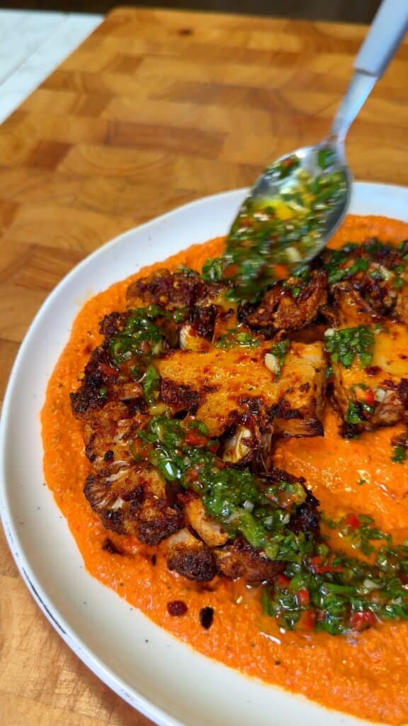 Mix the chimichurri: Stir parsley, oregano, chili, vinegar, olive oil, salt, and pepper. Let rest briefly to develop flavor.