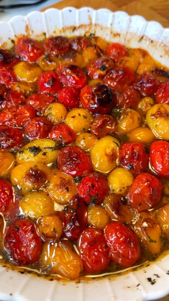 Prepare the tomatoes
 Place cherry tomatoes in a baking dish. Add garlic, olive oil, herbs, chili flakes, salt, and pepper. Toss to coat