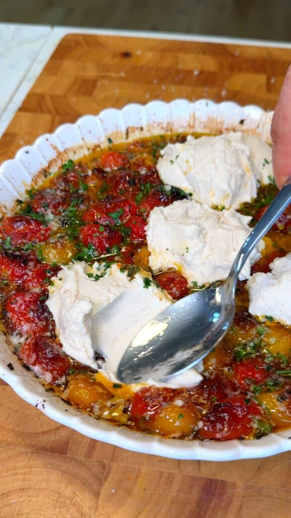 Assemble
 Top the roasted tomatoes with fresh herbs, parmesan, and spoonfuls of the creamy bean mix. Lightly mix, keeping some contrast between the tomatoes and dip.