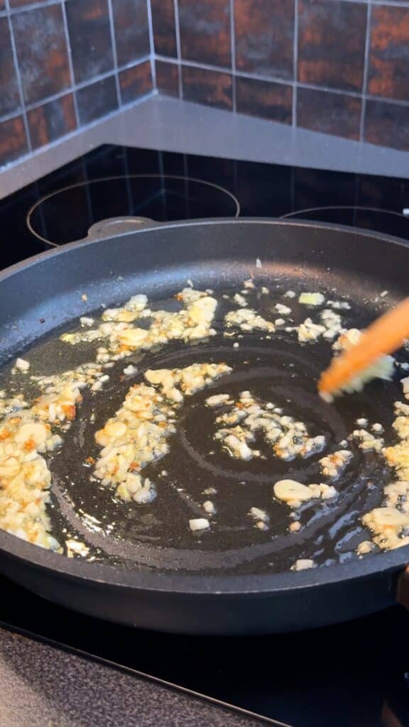 Warm olive oil and vegan butter in a large skillet. Add finely diced onion and cook until soft.