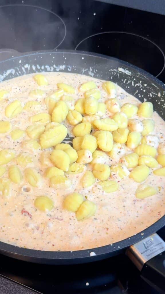 Add gnocchi and stir to coat. Cover and cook until tender and the sauce is creamy, loosening with a little water or broth if needed.