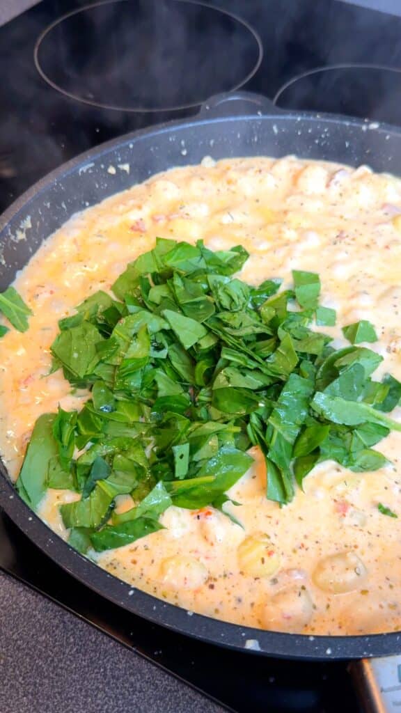 Stir in spinach until wilted, then mix in lemon juice if using. Taste and adjust seasoning.