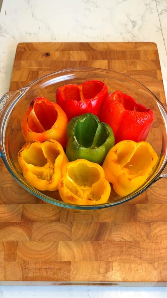 Prepare the Peppers Slice off the tops and remove the seeds. Dice the tops for the filling, brush the insides with olive oil, and roast until slightly softened.
