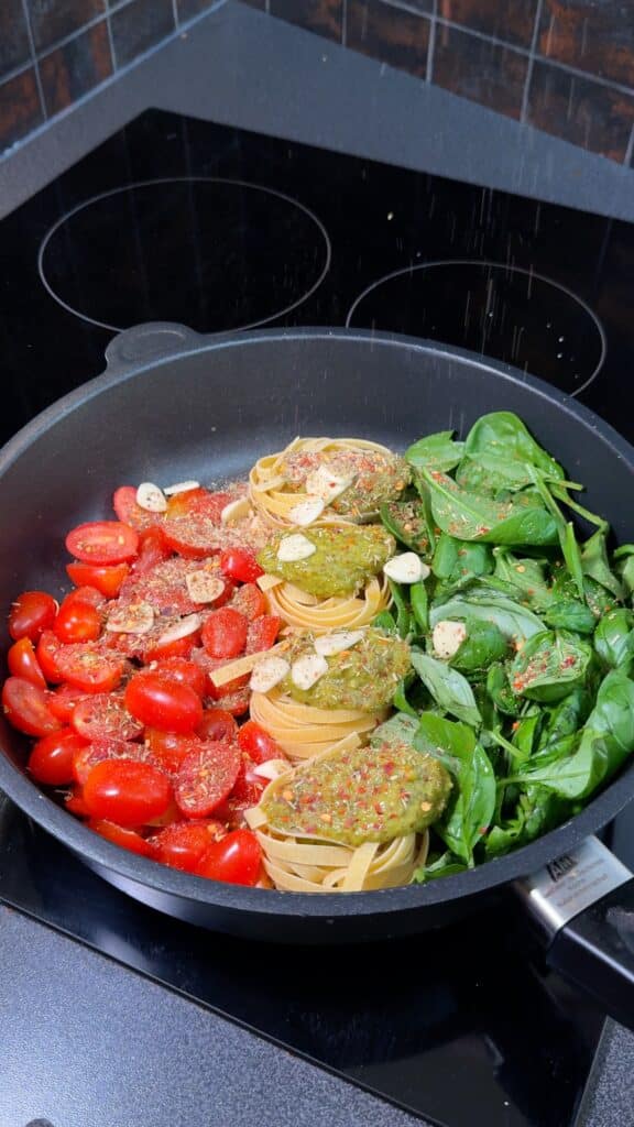 Season and Flavor:
 Spoon pesto over the pasta and sprinkle with Italian seasoning, salt, pepper, and chili flakes if you like a little heat.