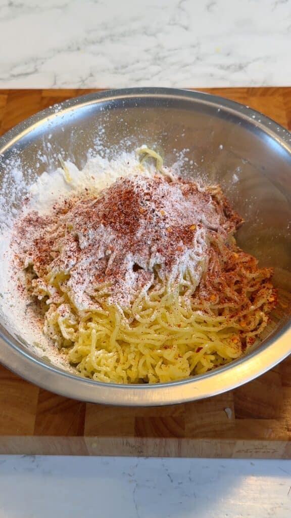 Mixing mashed potatoes with starch and spices to form a smooth dough