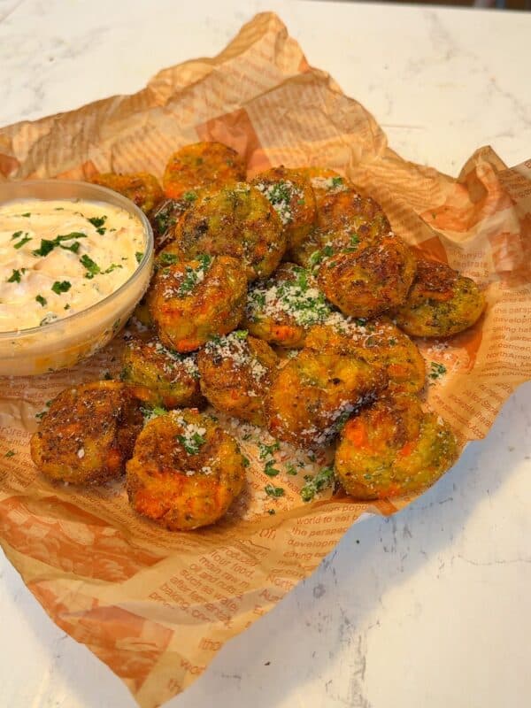crispy vegan veggie balls with dip on parchment paper