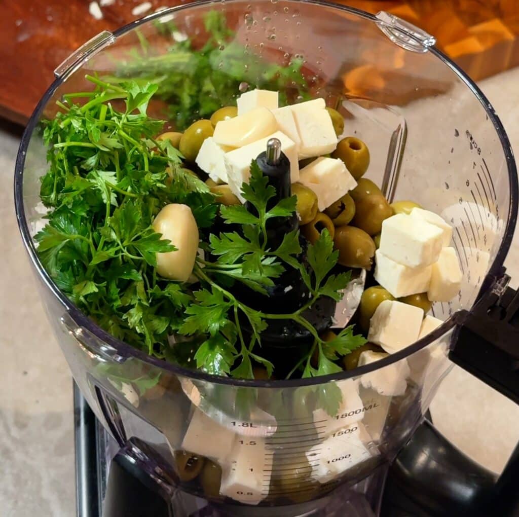 Add the olives, vegan feta, walnuts, parsley, garlic, olive oil, and lemon juice to a blender or food processor. Blend until creamy. If you like a bit of texture, stop earlier. If you want it smooth, blend a little longer and add a splash more olive oil.