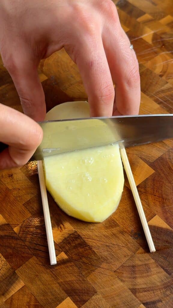 Straight cuts
Slice thin, close cuts straight across the plank, letting the chopsticks stop your knife. The tighter the cuts, the crispier the edges later.