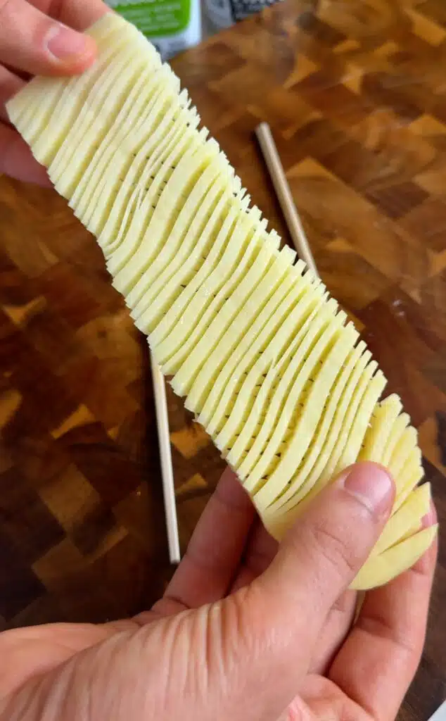Cut potato plank gently opened into an accordion pattern