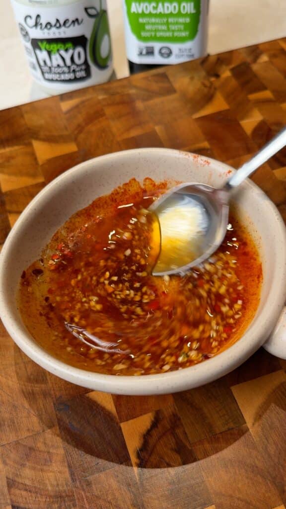 Garlic-herb marinade in the bowl
Stir the oil, garlic, herbs, and spices until it looks evenly speckled. This makes sure every brush gives you flavor, not just oil.