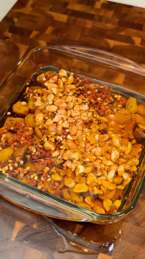 Add the flavor mix
While the oil is still hot, stir in chili flakes, sesame seeds, peanuts, salt, a little sugar, and any optional seasonings like soy sauce and vinegar.