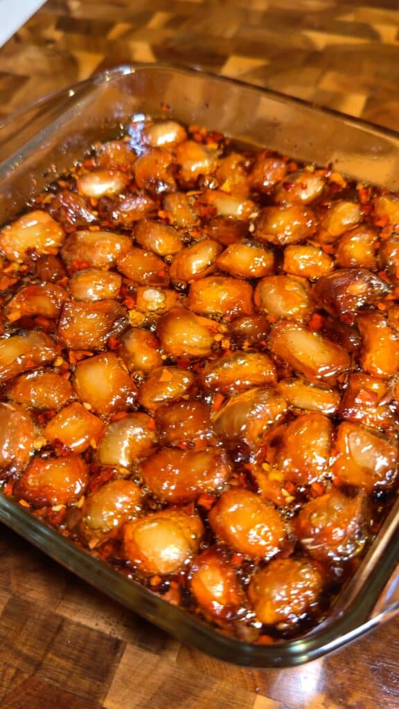 Infuse in the oven
Put the dish back in the oven briefly so the spices and peanuts can fully infuse the oil without burning.