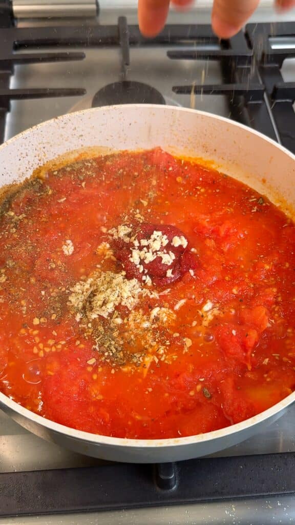 Season the base
Stir in garlic, tomato paste, Italian seasoning, salt, and pepper.