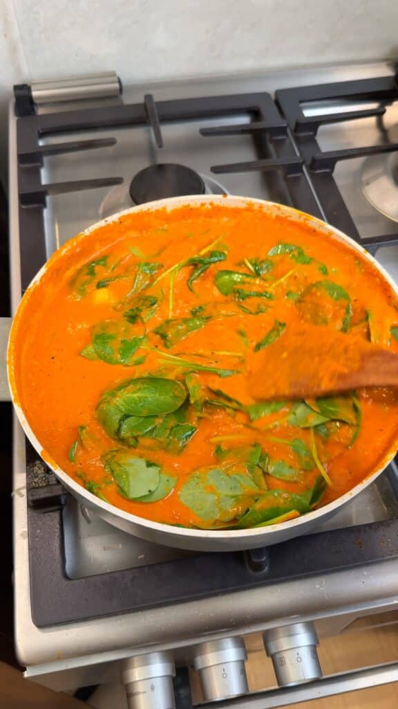 Wilt in the spinach
Stir in fresh spinach and let it cook down.