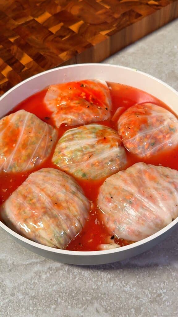 Add the tomato sauce
Pour the tomato sauce around and over the rolls until they’re nestled in a bright red bath.
