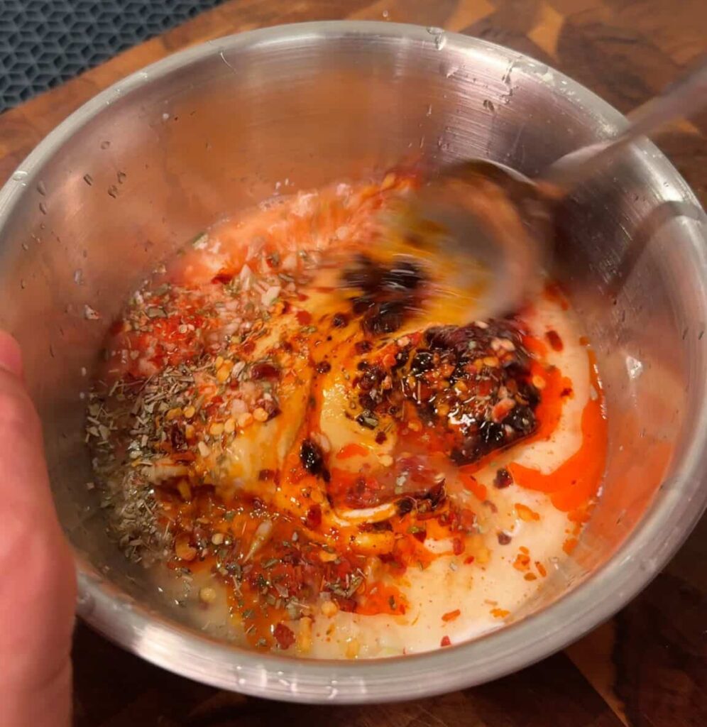 Make the dressing 
Whisk together vegan yogurt, vegan mayo, chili crisp, minced garlic, lemon juice, and red pepper flakes.