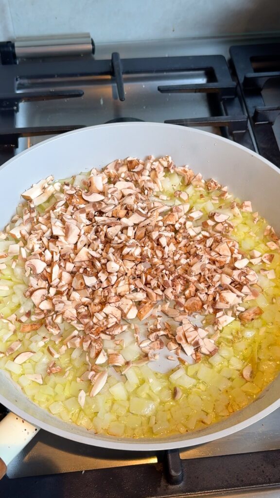 Start the ragù
Sauté diced onion until golden, then add chopped mushrooms and cook until all the moisture is gone.