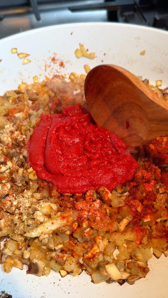 Build the flavour
Stir in tomato paste, soy sauce, paprika, cumin, garlic powder, chili flakes, and black pepper.