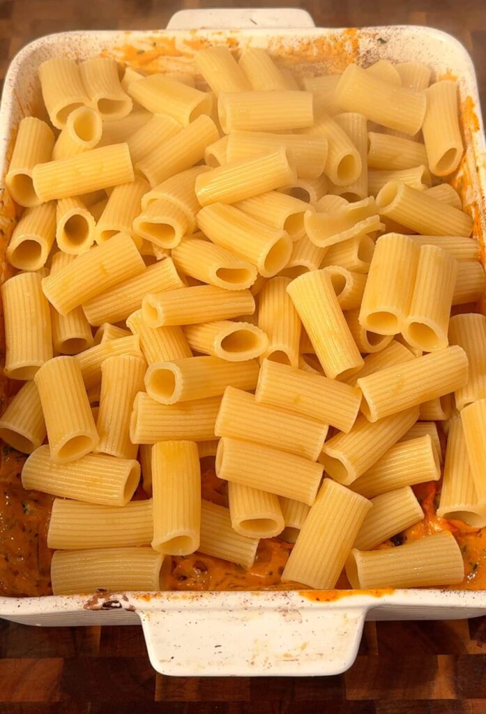 Add the pasta Toss in the cooked rigatoni and reserved pasta water. Mix until every piece is coated in the creamy sauce.