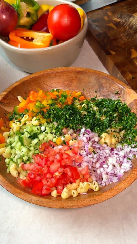 Prep the vegetables
Dice everything into small even cubes, chop the parsley, and toss with the pasta.