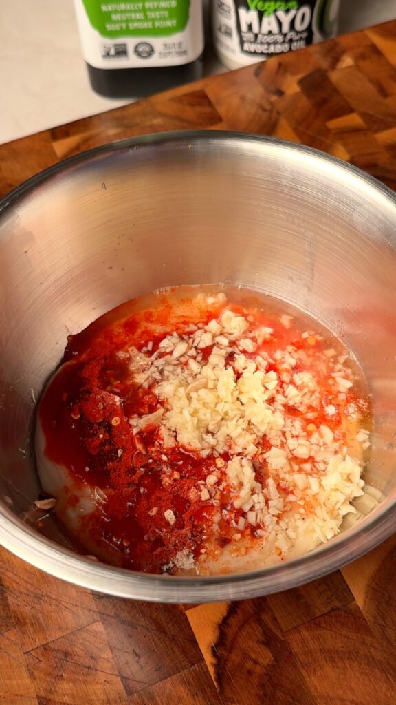 Make the garlic herb marinade
Mix avocado oil with salt, paprika, rosemary, thyme, and grated garlic until evenly combined.